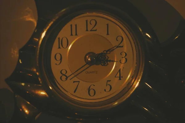 close up of a clock on a black background