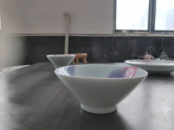 bowl with white sink and ceramic bowls on table in bathroom