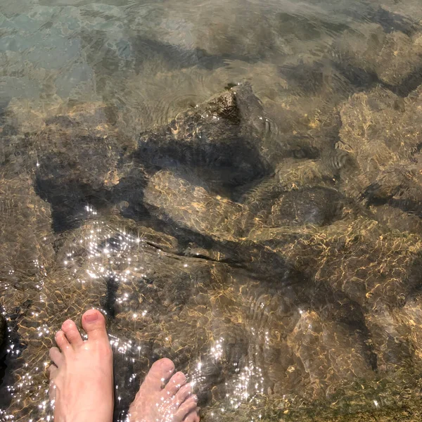 feet of a woman in the water