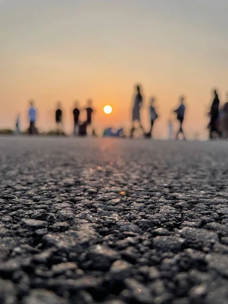 a group of people walking on the road.