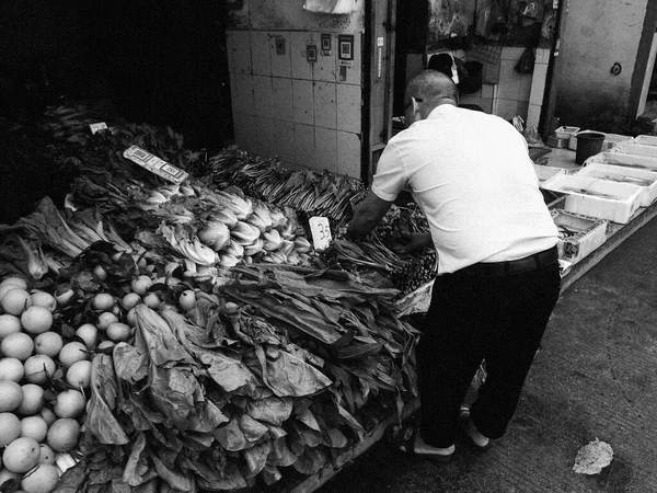 black and white image of a man in the market