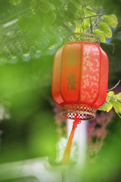 red lantern with a candle on a green background