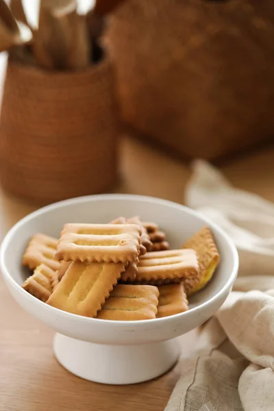homemade cookies with cinnamon sticks on wooden background