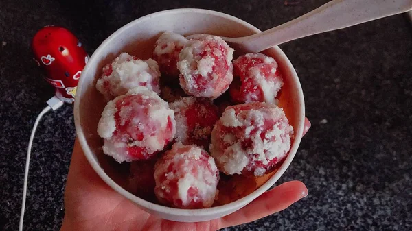 frozen ice cream in a bowl on a black background.