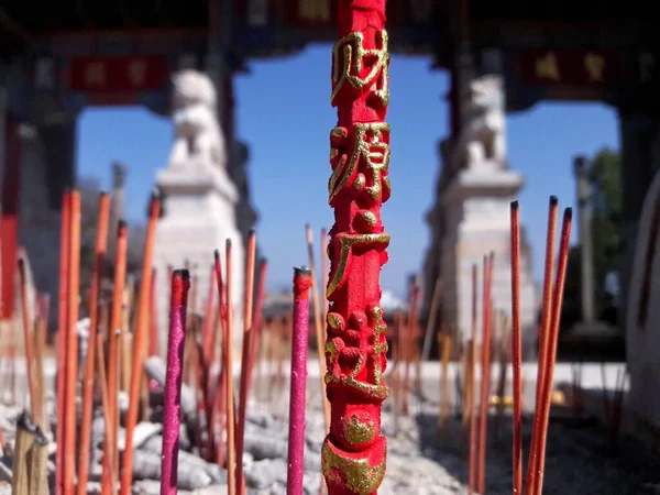 red incense sticks in the temple