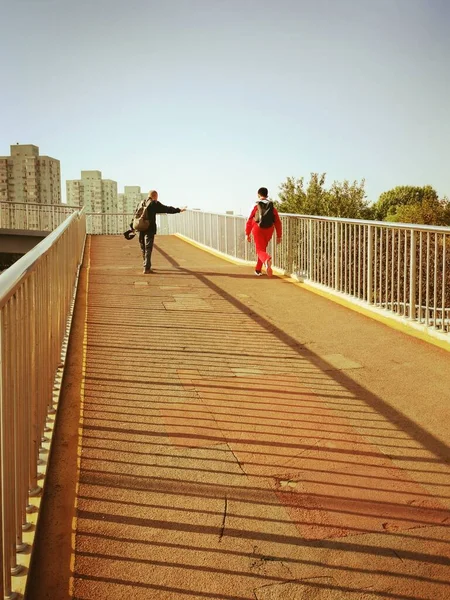 couple walking on the bridge in the city of bilbao