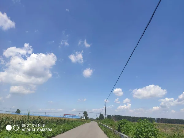 beautiful landscape with a road and a blue sky