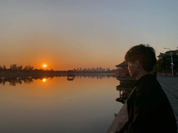 silhouette of a man on the lake