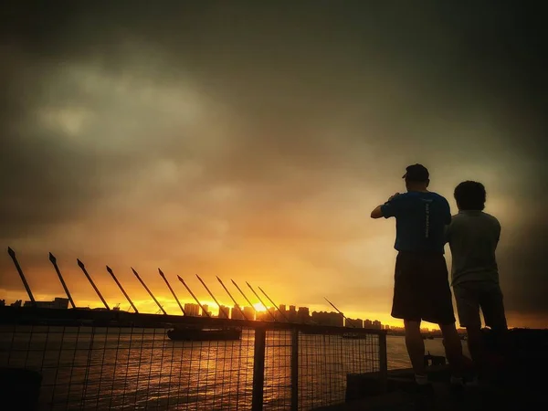 silhouette of a man and woman on the beach