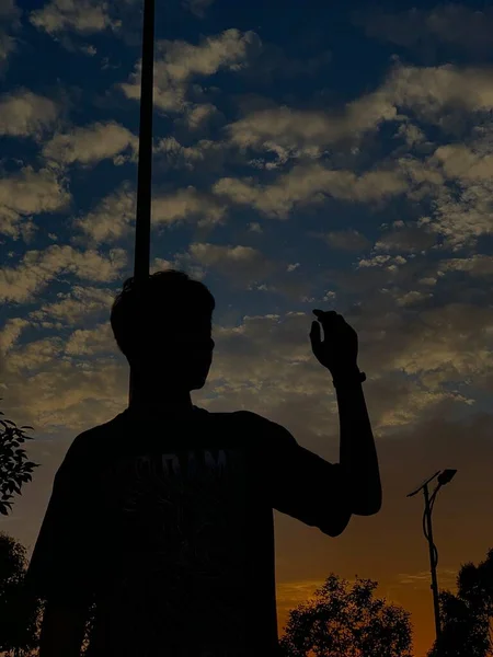 silhouette of a man with a sword on the background of the sunset