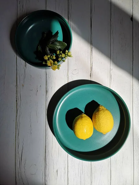 lemon and green tea in a bowl on a wooden background