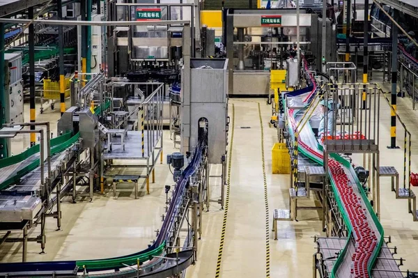 industrial factory, technology and people concept-close up of a man and woman with machine in the background