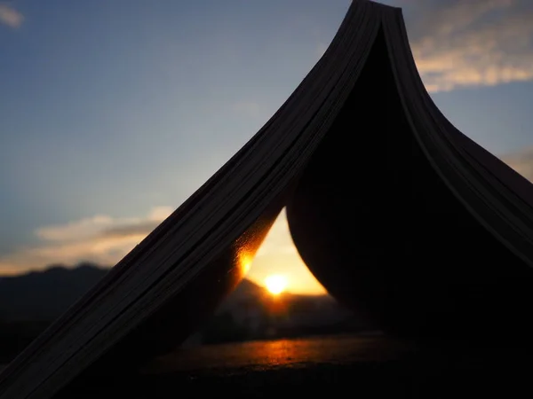 open book with a beautiful sunset
