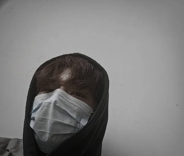 a man in a mask and a protective face masks.