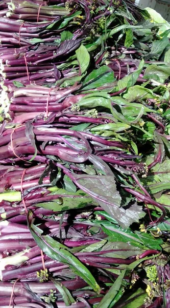 fresh purple and green beans on a market stall
