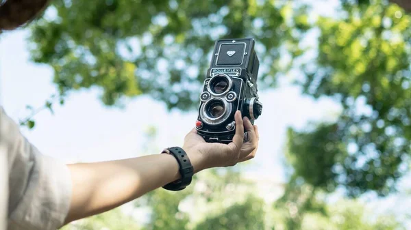 woman taking photo of camera in the forest