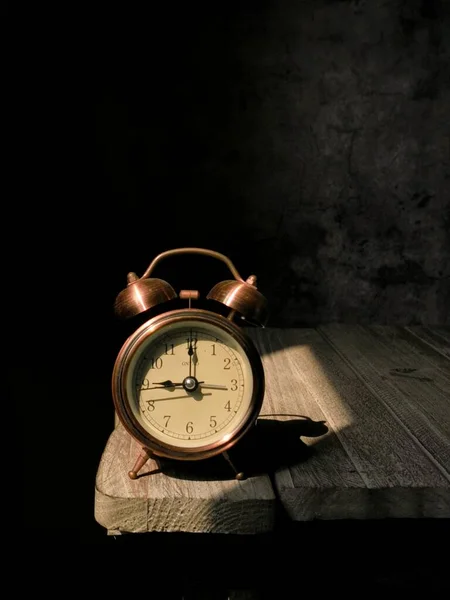 old alarm clock on black background