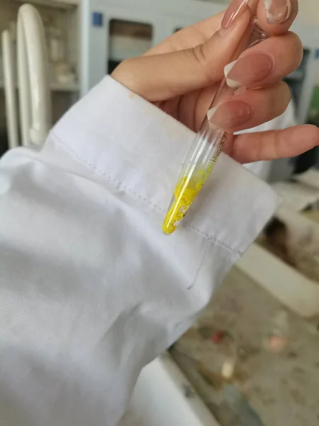 close up of a hand holding a surgical mask