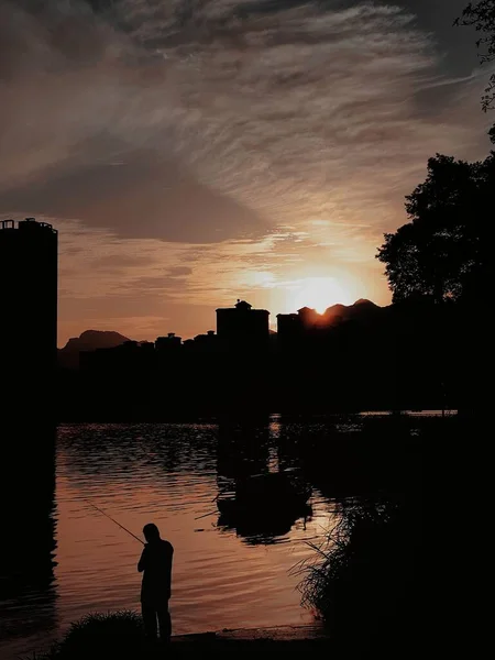 silhouette of a man and woman on the background of the sunset