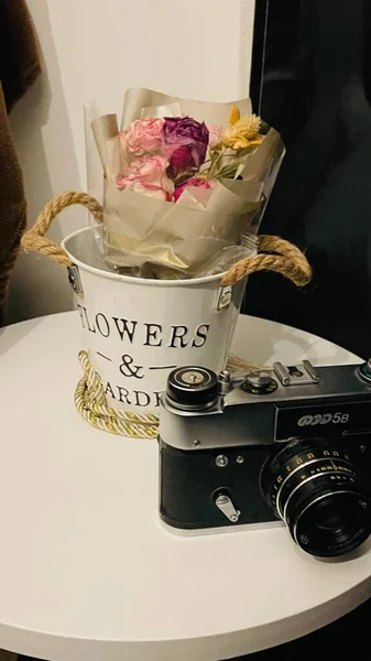vintage camera with flowers and a bouquet of roses