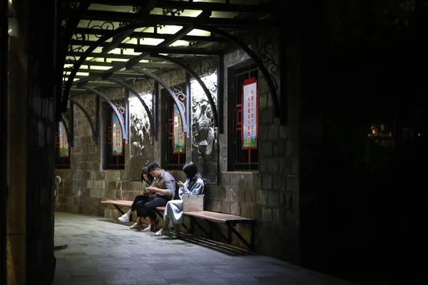 a man in a cafe with a backpack and a woman in a restaurant