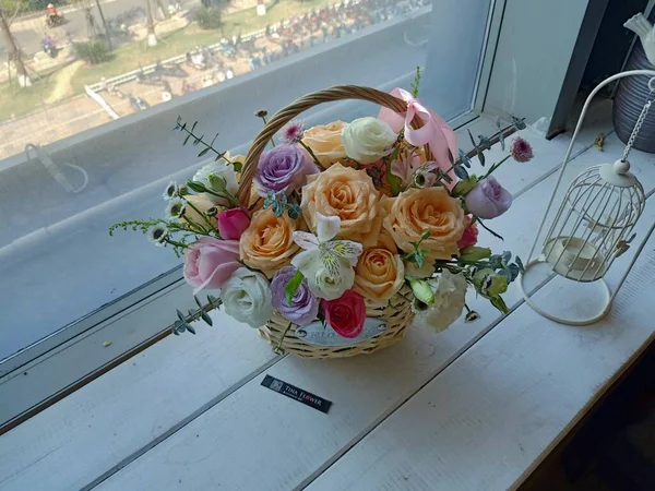 beautiful bouquet of roses in a vase on a wooden table
