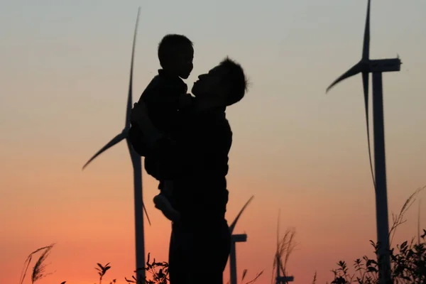 silhouette of a man with a sword on the beach