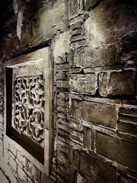 old stone wall with a large window