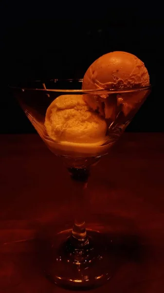a glass of ice cream with a red background
