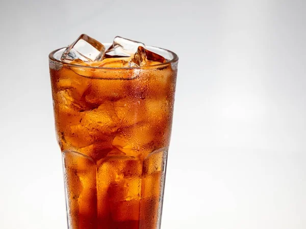 cola with ice cubes on white background