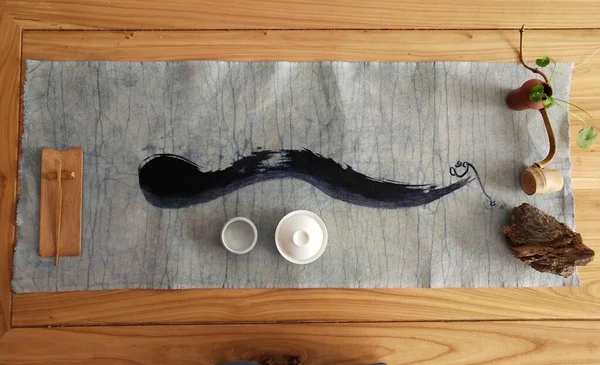 wooden table with a cat and a knife on a white background