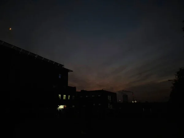 silhouette of a house in the night sky