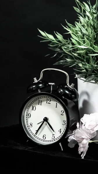 alarm clock on black background