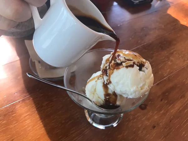 ice cream in a cup with chocolate and vanilla.