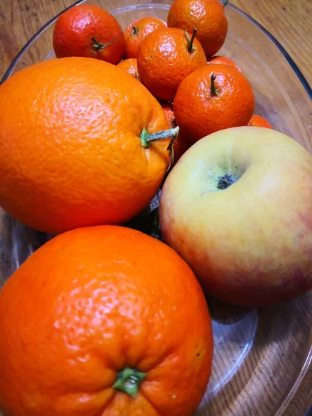 fresh orange and red oranges on wooden table
