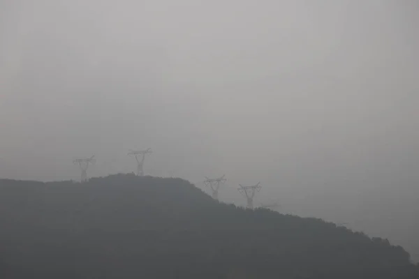 view of the mountains in the fog