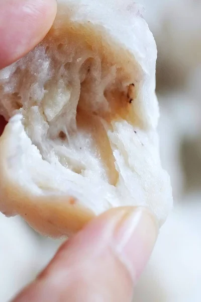 close up of a hand holding a white sponge