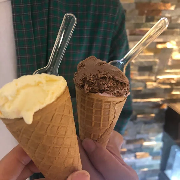 woman with ice cream in the hands of a young girl with a scoop of chocolate.