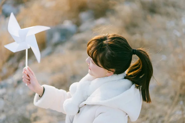 young woman with a toy kite on the beach