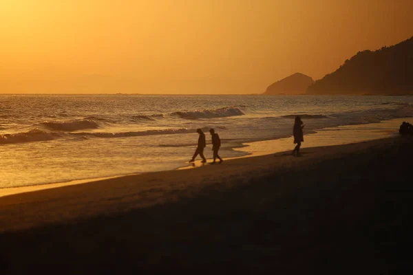 silhouette of a man and woman on the beach