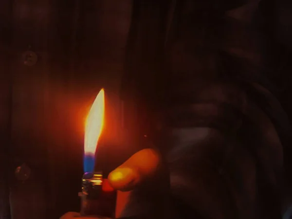 candle in the hands of a man