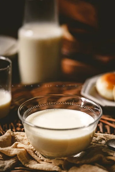 homemade milk and eggs in a glass bowl on a wooden table