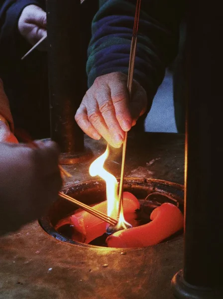 man\'s hands making a fire in the kitchen