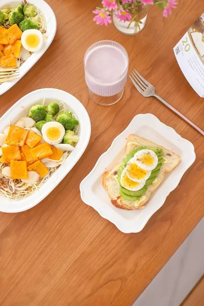 breakfast with eggs, cheese and egg, served with fresh salad