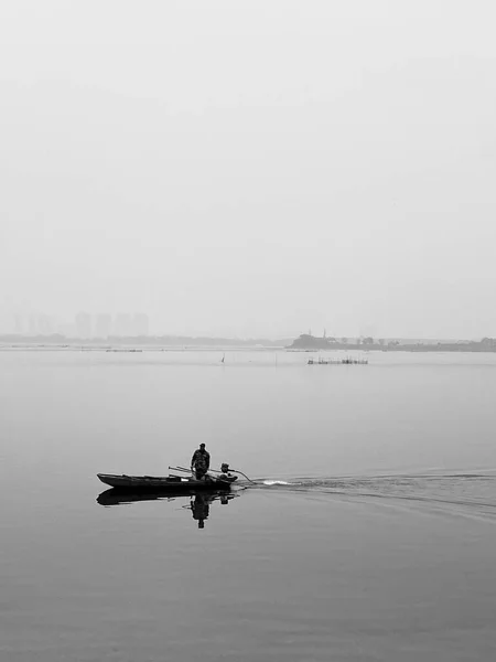 silhouette of a man on the lake