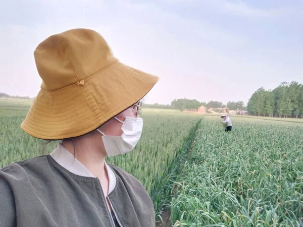 farmer with hat and a straw bag on the field