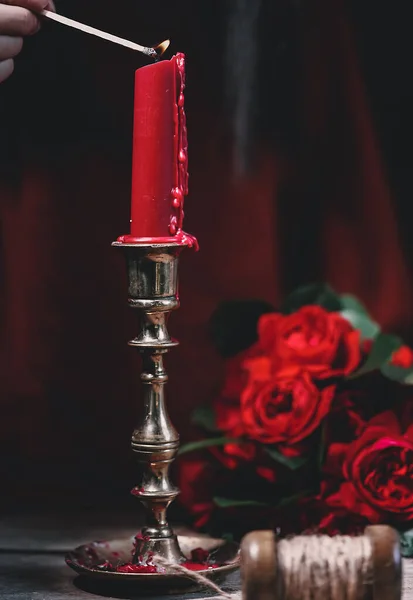 rose and candle in a vase on a table