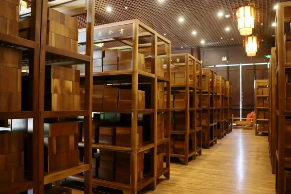 warehouse shelves with boxes in the background