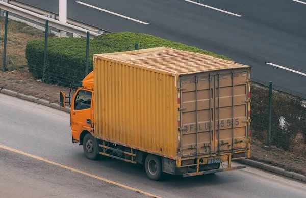 truck with trucks and boxes on the road