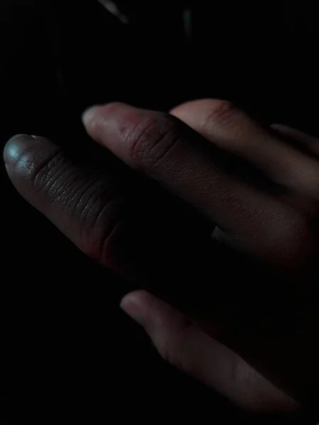 hand of a man with a black background